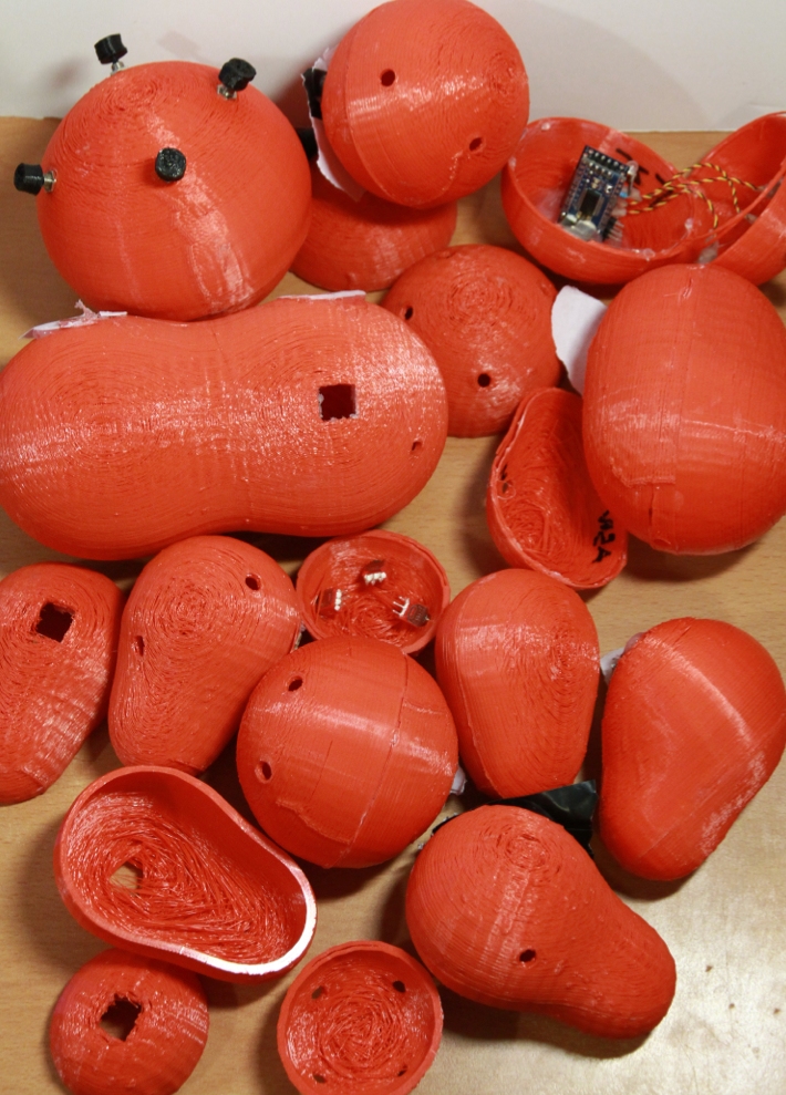 A pile of orange 3D-printed instrument prototypes